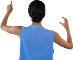 Rear view of businesswoman touching interface while holding something