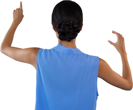 Rear view of businesswoman touching interface while holding something