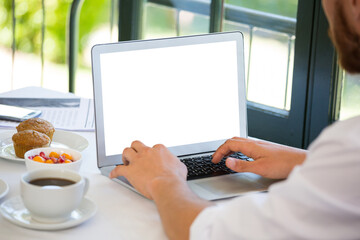 Businessman using laptop at table in restaurant