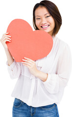 Happy woman holding heart shape paper