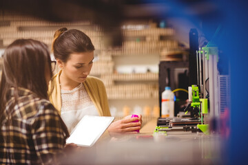 Graphic designers interacting while using digital tablet
