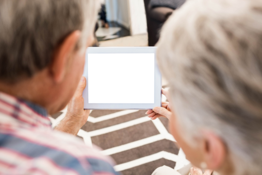 Rear view of senior couple using tablet
