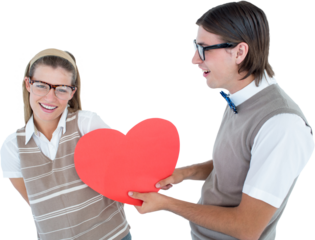 Geeky hipster offering red heart to his girlfriend 