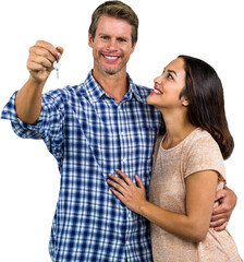 Happy couple embracing while holding home keys
