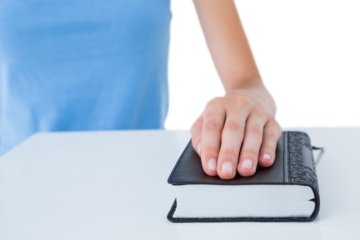 Woman praying with bible