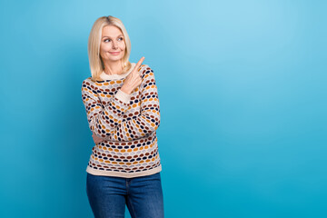 Portrait of senior gorgeous lady wear stylish clothes arm direct empty space interesting deal isolated on blue color background