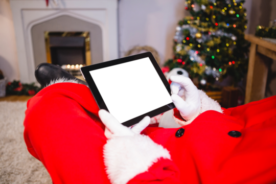 Santa claus sitting and using digital tablet