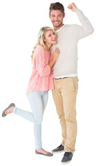 Attractive couple smiling and cheering