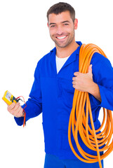 Smiling electrician with wire roll and multimeter