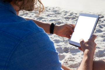 Man using digital tablet on the beach