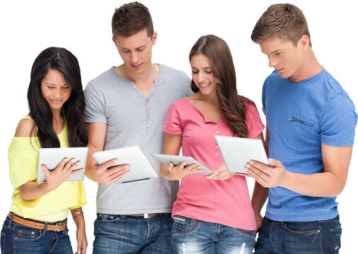 Four friends looking at their tablets and smiling
