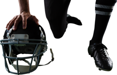 American football player resting his hands on head gear