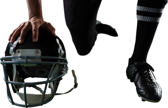 American football player resting his hands on head gear