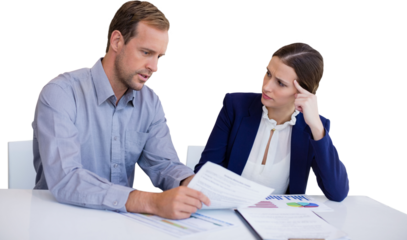 Business people analyzing data while sitting qagainst white background