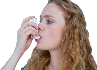 Close-up of woman using the asthma inhaler