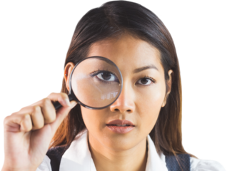 Businesswoman looking through magnifying glass