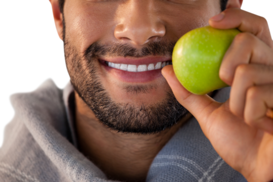 Close-up of smiling man holding apple