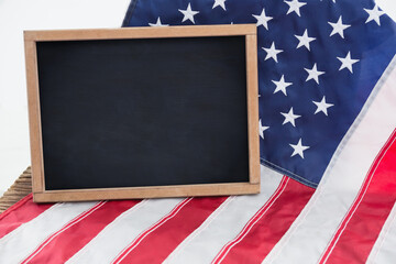 Blank chalkboard on American flag