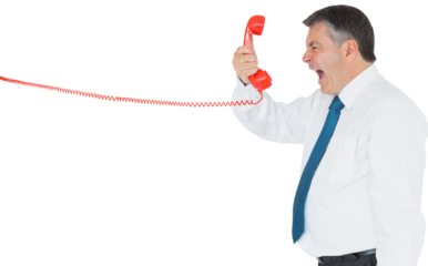Businessman screaming directly into the handset 
