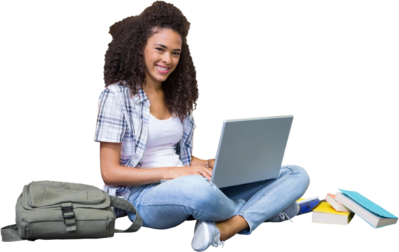 Student sitting on floor in library using laptop