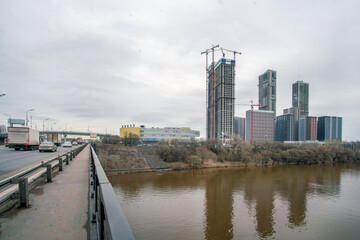 New residential buildings  in construction process in Trikotazanaya district of Moscow  and Moscow River