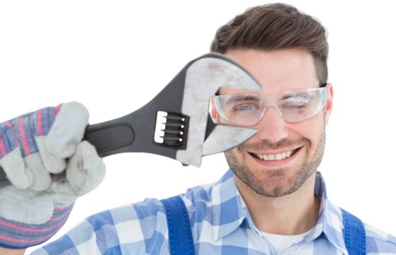 Confident repairman wearing protective glasses while holding wrench