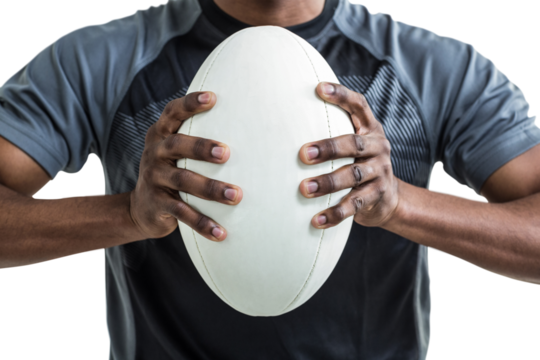 Cropped image of sportsman pressing rugby ball - Powered by Adobe