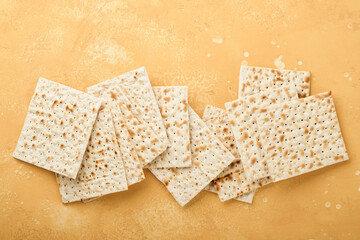 Matzah Passover celebration concept. Traditional ritual Jewish bread on sand color old wall background. Passover food. Pesach Jewish holiday of Passover celebration concept. Passover food.