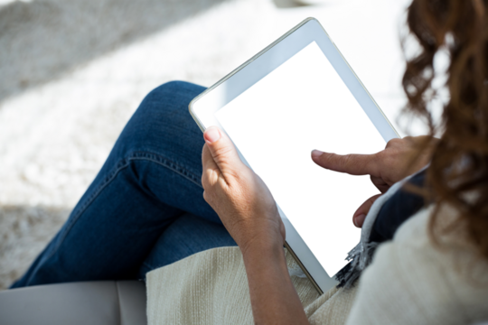 Woman pointing at digital tablet outdoors