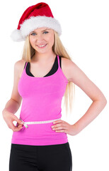 Fit festive young blonde measuring her waist