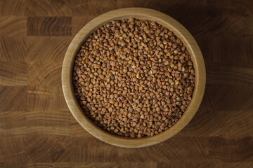 Buckwheat on a wooden board. Buckwheat on top. Buckwheat in a bowl. Cereals