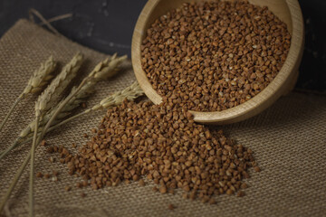 Buckwheat on a wooden board. Buckwheat on top. Buckwheat in a bowl. Cereals