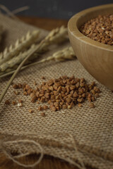 Buckwheat on a wooden board. Buckwheat on top. Buckwheat in a bowl. Cereals