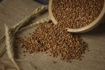 Buckwheat on a wooden board. Buckwheat on top. Buckwheat in a bowl. Cereals