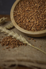Buckwheat on a wooden board. Buckwheat on top. Buckwheat in a bowl. Cereals
