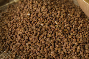 Buckwheat on a wooden board. Buckwheat on top. Buckwheat in a bowl. Cereals