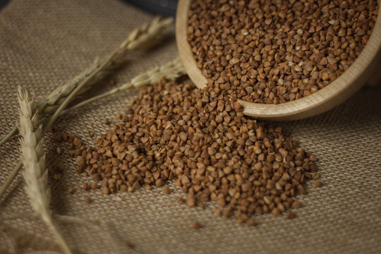 Buckwheat on a wooden board. Buckwheat on top. Buckwheat in a bowl. Cereals © Artem Shunin