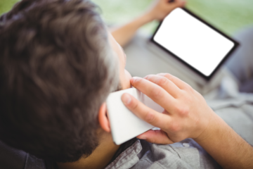 Man talking on phone at park