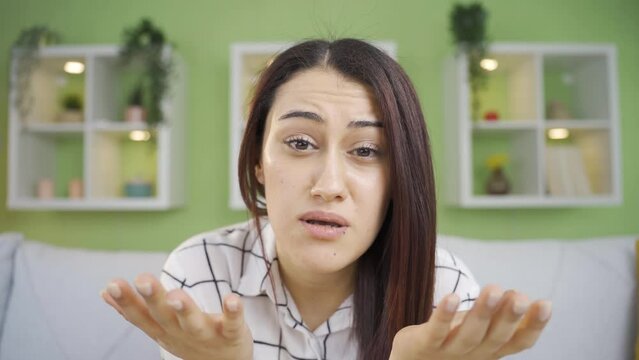 Frustrated Depressed Young Woman Speaks To The Camera About Her Grief.
Unhappy And Sad Young Woman Expresses Her Resentment By Looking At The Camera And Is Sad.
