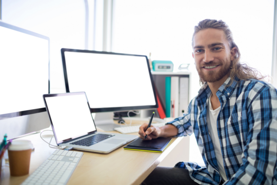 Portrait of male executive sitting at his desk