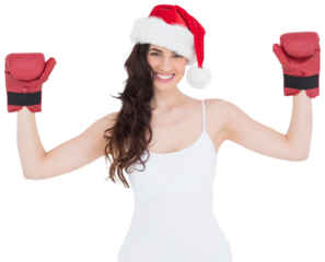 Festive brunette in boxing gloves with arms raised