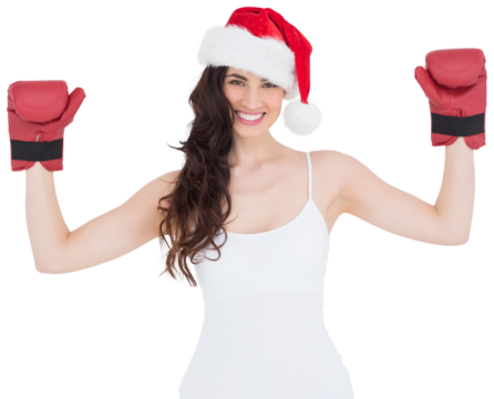 Festive brunette in boxing gloves with arms raised