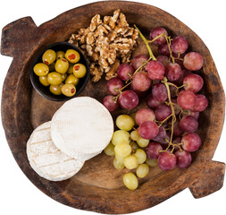 Grapes, walnut and olive on wooden bowl