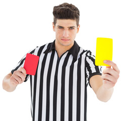 Portrait of referee showing red and yellow card