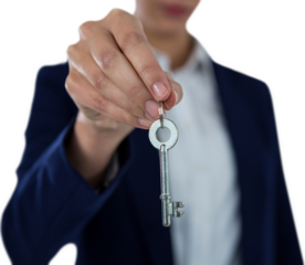 Mid section of businesswoman showing house key
