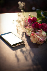 Obraz premium High angle view of mobile phone with flowers
