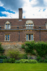 Brick wall and traditional windows of Jesus College in Cambridge