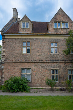 Brick wall and traditional windows of Jesus College in Cambridge