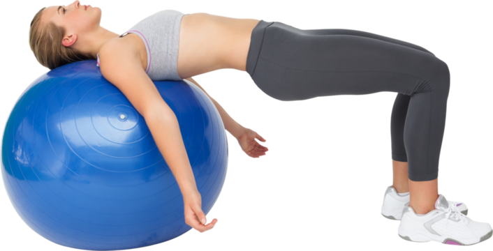 Fit young woman exercising with fitness ball