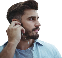 Thoughtful handsome man listening to music in headphones